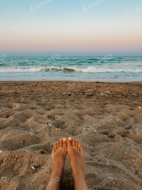 Preview: Woman legs barefoot. Sea blue aquamarine waves sand beach. ocean foam.
