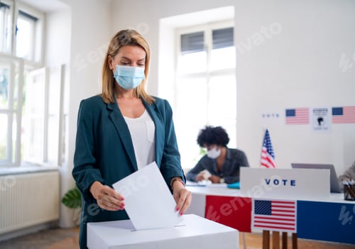 Preview: Young woman putting her vote in the ballot box, usa elections and coronavirus