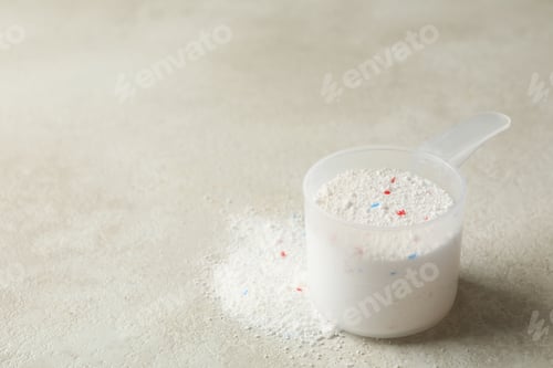 Preview: Scoop with washing powder on light beige textured background