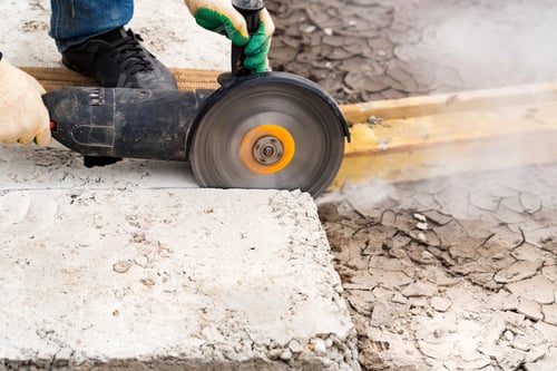Preview: Close up worker cuts concrete with circular saw