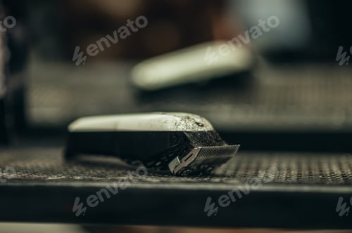 Preview: Close shot of a hear trimmer full of hair in a barbershop