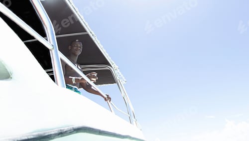 Preview: African american man with drink on the yacht