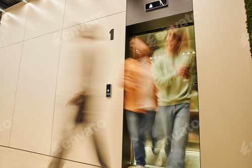 Preview: motion blur of energetic businessmen getting out elevator in contemporary coworking office, long