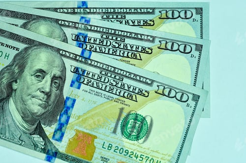 Preview: Top view of hundred-dollar banknotes isolated on a white background