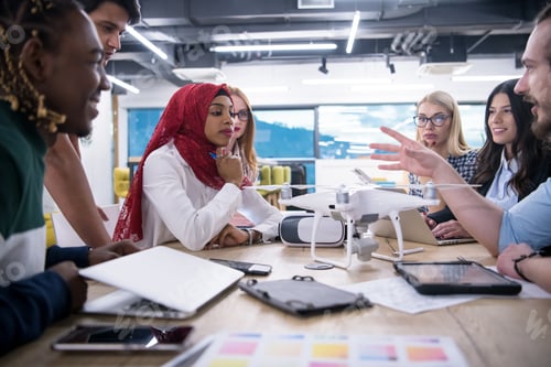 Preview: multiethnic business team learning about drone technology