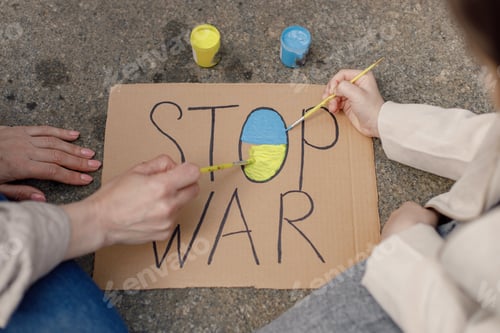 Preview: Woman and girl painting a poster Stop War with blue and yellow colors