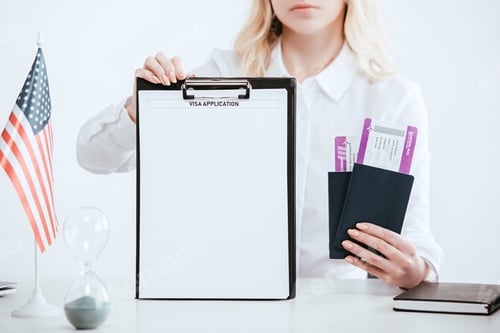 Preview: cropped view of woman holding passports with tickets and clipboard with empty blank with visa