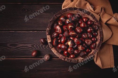 Preview: roasted chestnuts, in a wooden plate, top view, homemade, no people,