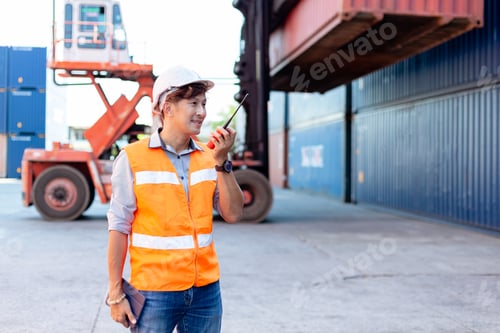 Preview: Foreman using radio walkie talkie control loading containers box in cargo for import export,