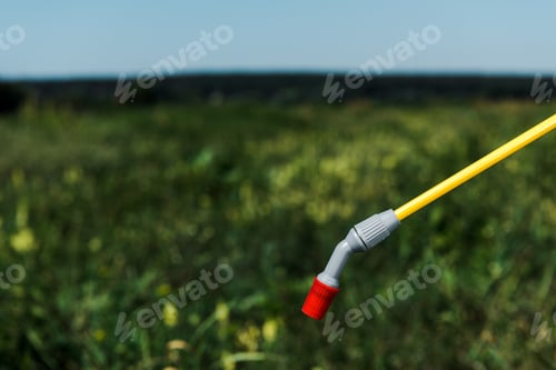 Preview: selective focus of toxic spray near green grass outside
