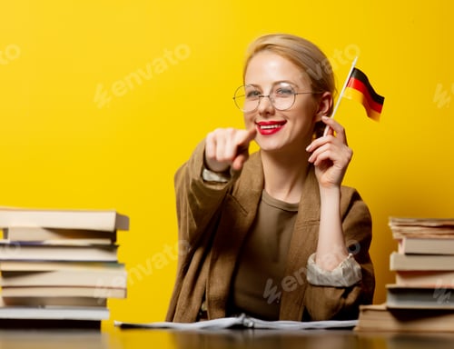 Preview: Style blonde woman sitting at table with books and flag of Germany on yellow background