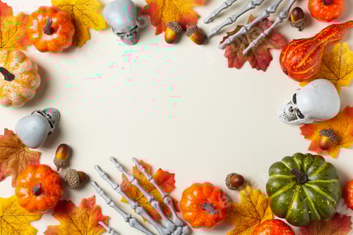 Preview: Halloween greeting card with pumpkin, skulls, bony hands and leaves