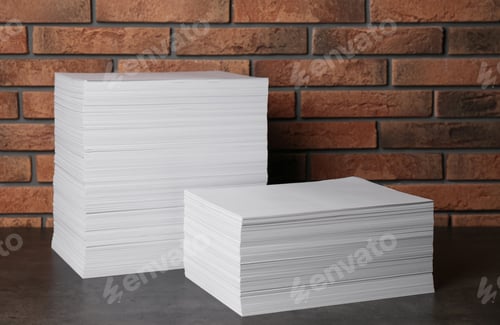 Preview: Stacks of paper sheets on black table