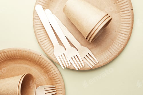 Preview: Sustainable tableware with eco paper cups and forks on green background minimalist concept