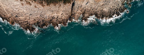 Preview: Aerial view of rocky beach and sea with clear blue water at sunset. Coast of the Adriatic Sea at