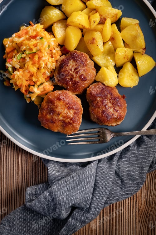 Preview: Meatballs served with fired potatoes.