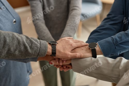 Preview: Group of Adults Stacking Hands in Group Exercise