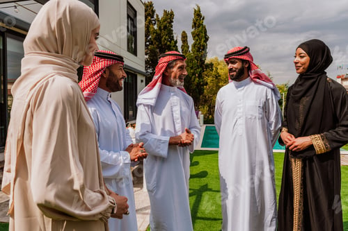 Preview: Arab multi-generational family gathering and discussing outdoors