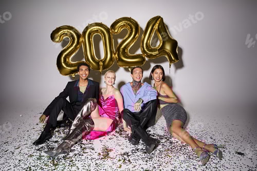 Preview: smiling multicultural friends sitting near confetti and balloons with 2024 numbers, Happy New Year