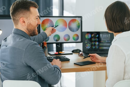 Preview: Talking with each other about new ideas. Two designers working together in the office