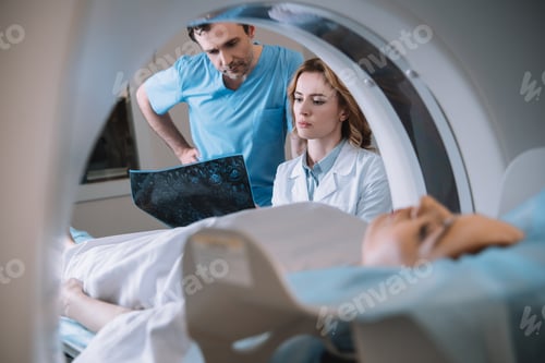 Preview: selective focus of thoughtful doctors looking at x-ray diagnosis during patients diagnostics on ct