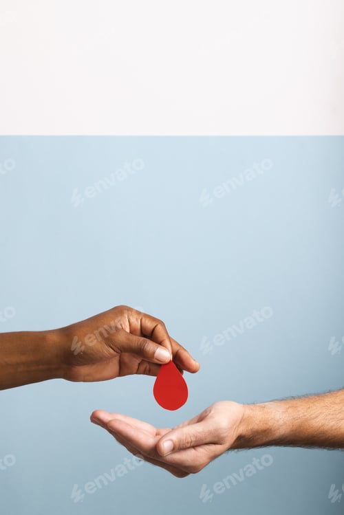 Preview: Hands of biracial man giving blood drop to caucasian man, on blue and white background, copy space