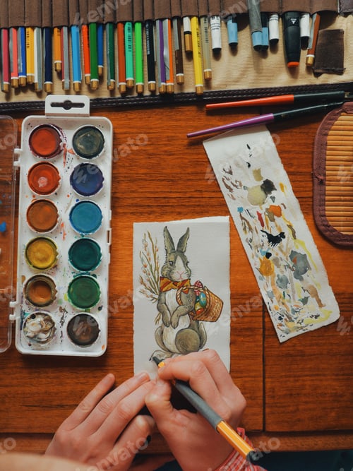 Preview: female artist painter painting a picture of a easter bunny