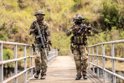 Preview: Two armed special forces soldiers in full tactical gear patrollin
