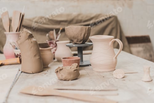 Preview: handmade pots, sculpted clay bowl and pottery equipment on wooden table