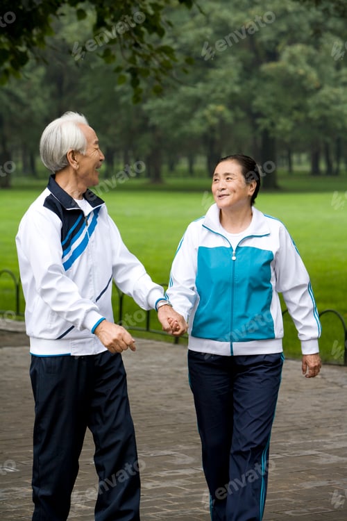 Preview: Senior Couple Walking Hand-In-Hand Through a Park