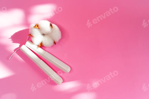 Preview: Feminine hygienic tampons on pink paper background