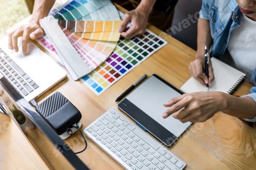 Preview: Team of young colleagues creative graphic designer working on color selection and drawing on