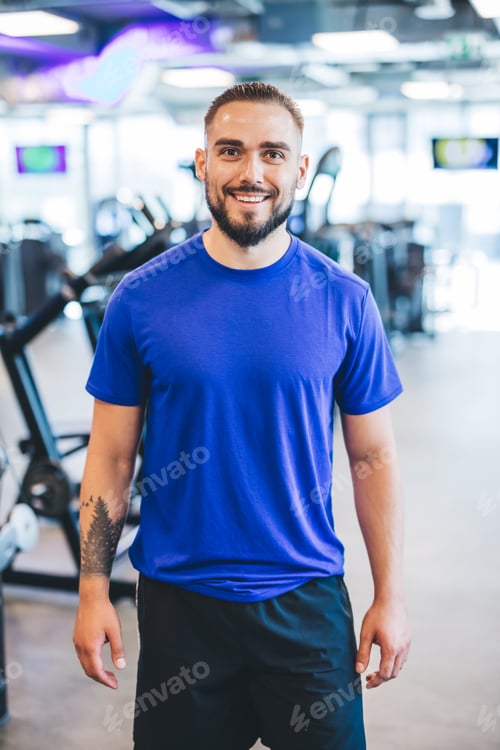 Preview: Happy man standing in a gym.