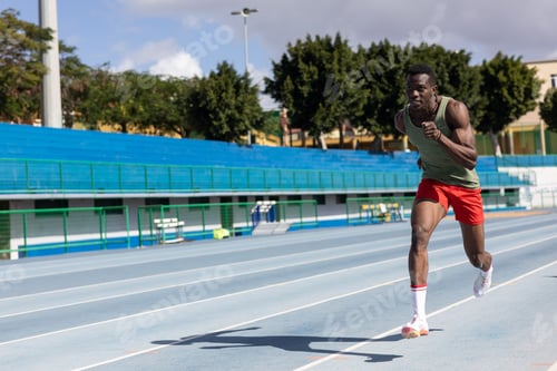 Preview: african man running on athletics track