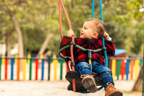 Preview: cute baby having fun in a swing
