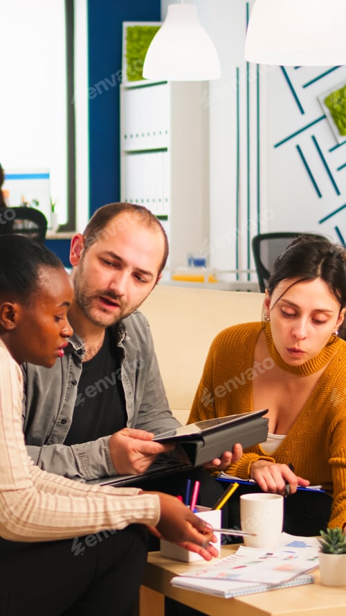 Preview: International business team talking to african woman mentor
