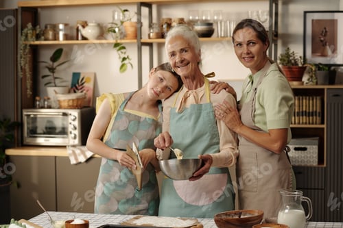 Preview: Senior Caucasian Woman Baking with Middle Aged and Teenage Caucasian Daughters