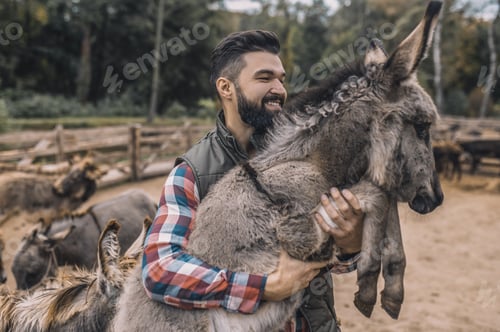 Preview: A farmer holding a donkey and smiling