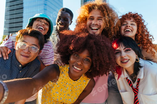 Preview: Multiethnic group of young friends meeting and having fun outdoors