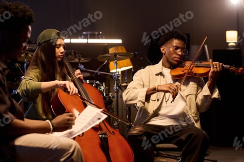 Preview: Multiethnic Young Adults Playing String Instruments during Music Rehearsal