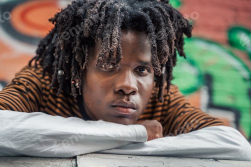 Preview: Portrait of young handsome stylish black man with natural hair dreadlocks. Afroamerican guy. Stairs,