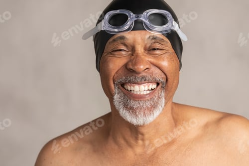 Preview: Senior African American swimmer wearing a swim cap and goggles