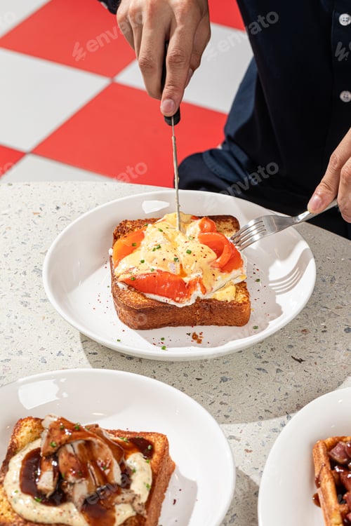 Preview: Person Cutting Open Savory French Toast Breakfast Dish