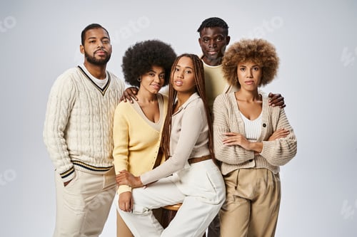 Preview: group of stylish african american friends standing in elegant attire on grey background, Juneteenth