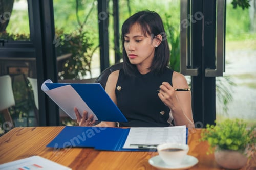 Preview: hands writing notebook diary with coffee cup and smartphone on wood desk