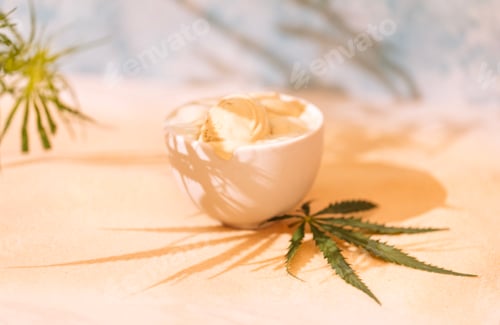 Preview: A white ceramic bowl with delicious ice cream and a cannabis leaf