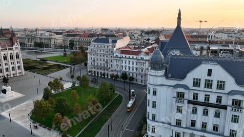 Preview: Budapest Tram passing through city neighbourhood in beautiful golden hour