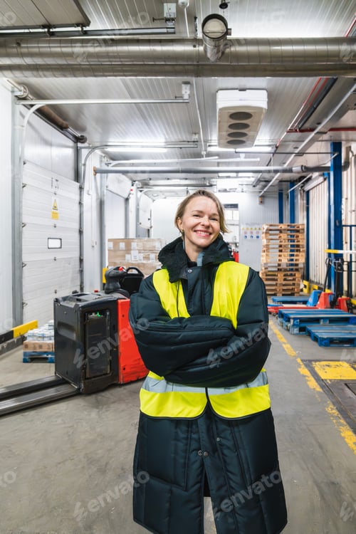 Preview: Woman warehouse worker protecting from cold in logistics storage