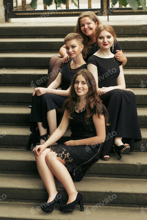 Preview: gorgeous luxury women in black dresses posing smiling on stairs under tree
