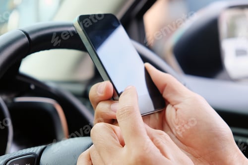 Preview: Close Up of Hands Using Mobile Phone in Car